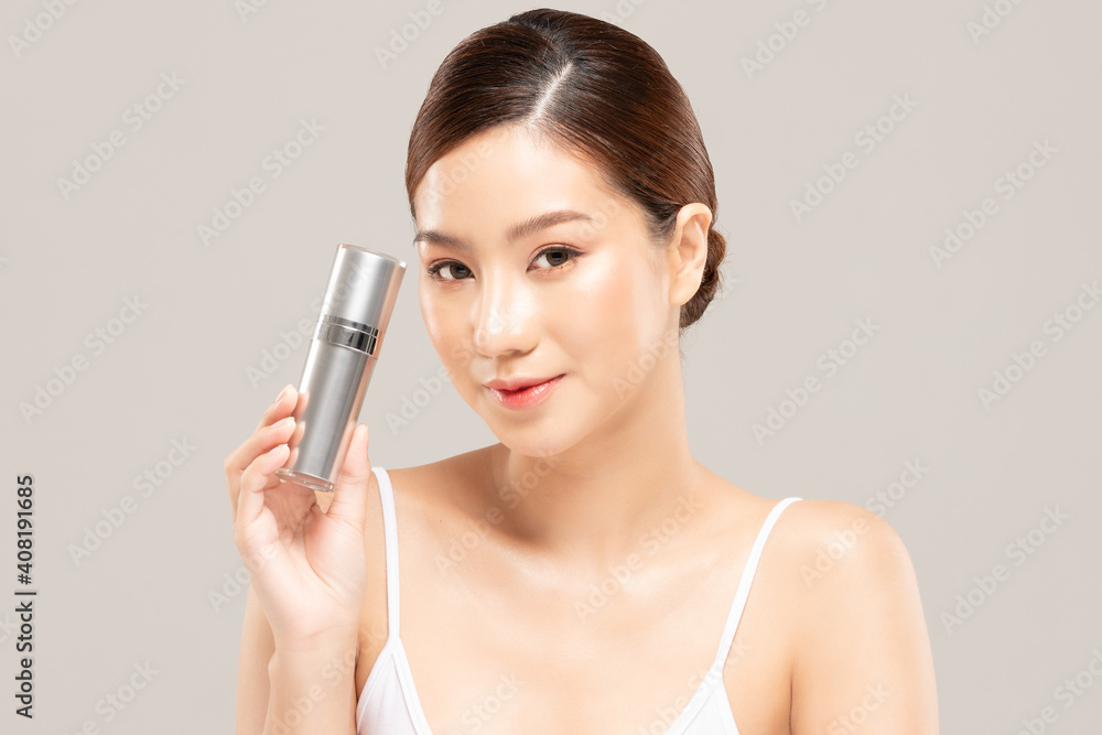 Beauty asian woman hold bottle cosmetic cream lotion  and cheerful.