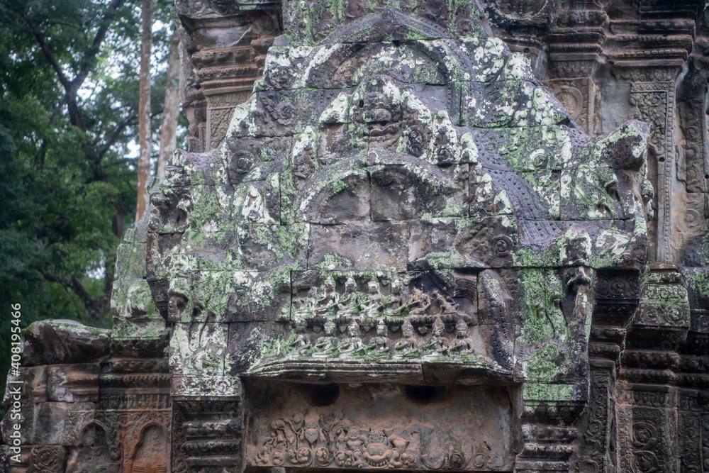 Та Prohm is the temple, it rains in the rainy season.The preserved symbiosis of stone and wood allows us to see Ta Prohm in this form.Bas-relief.(Cambodia, 04.10. 2019). Та Prohm is the temple, it rains in the rainy season.The preserved symbiosis of stone and wood allows us to see Ta Prohm in this form.Bas-relief.(Cambodia, 04.10. 2019).
