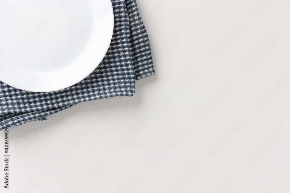 The white table had a white empty plate over the tablecloth. Place for placing text. The white table had a white empty plate over the tablecloth. Place for placing text.