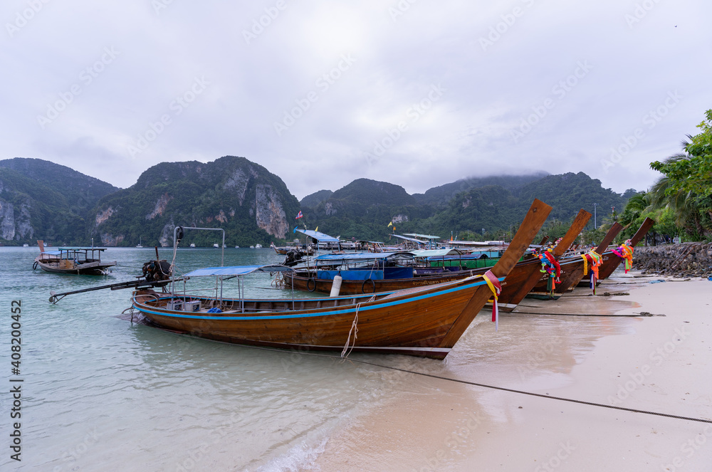 Thai traditional wooden longtail boat at Koh Phi Phi island in Krabi province. Ao Nang, Thailand. Thai traditional wooden longtail boat at Koh Phi Phi island in Krabi province. Ao Nang, Thailand.