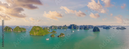 Aerial view panorama of floating fishing village and rock island, Halong Bay, Vietnam, Southeast Asia. UNESCO World Heritage Site. Junk boat cruise to Ha Long Bay. Popular landmark of Vietnam