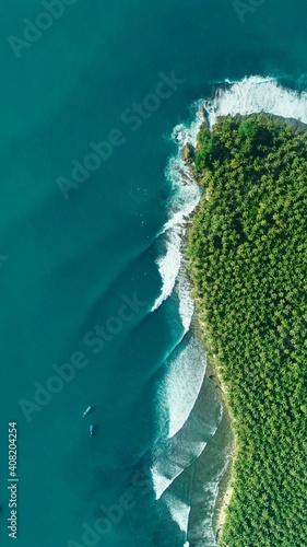 Fototapeta Naklejka Na Ścianę i Meble -  Aerial Drone World-Class Waves on Tropical Island Coast Palm Trees 