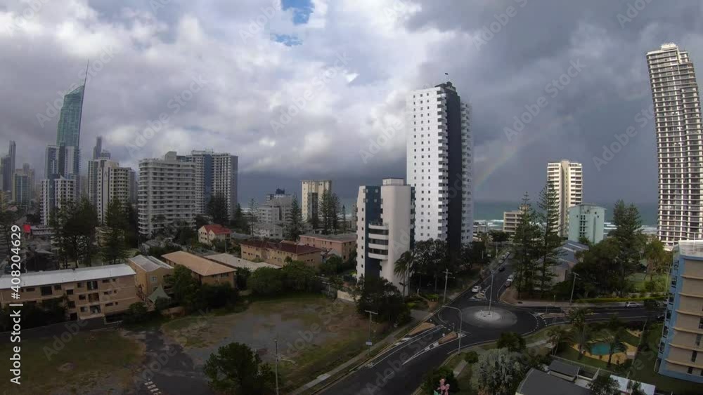 Time lapse of dark stormy clouds forming passing over the city scape building of the gold coast in Australia. You can also see a rainbow forming by the ocean and the famous Q1 building in the distance Time lapse of dark stormy clouds forming passing over the city scape building of the gold coast in Australia. You can also see a rainbow forming by the ocean and the famous Q1 building in the distance