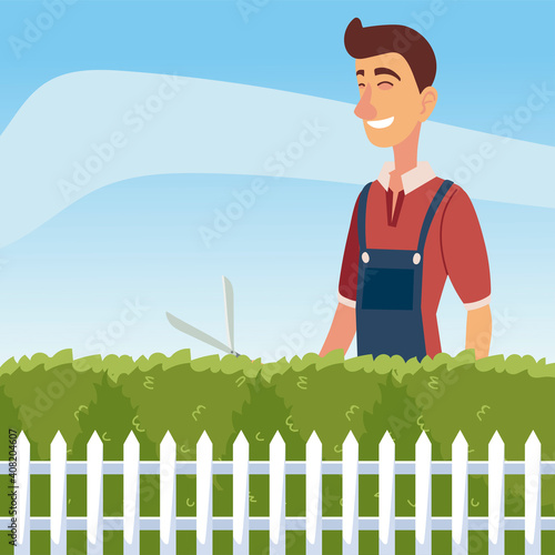 gardening, man trimming a bush or tree with big clippers