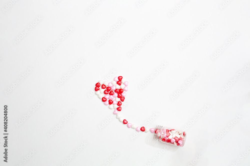 Sweets - hearts in small glass bottles. Colorful Valentines Day heart shaped candy with copy space. Sainte Valentine, mother's day greeting cards, invitation. Sweets - hearts in small glass bottles. Colorful Valentines Day heart shaped candy with copy space. Sainte Valentine, mother's day greeting cards, invitation.