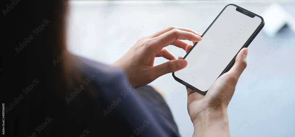 Close up view of businesswoman holding mobile phone with blank screen. Close up view of businesswoman holding mobile phone with blank screen.