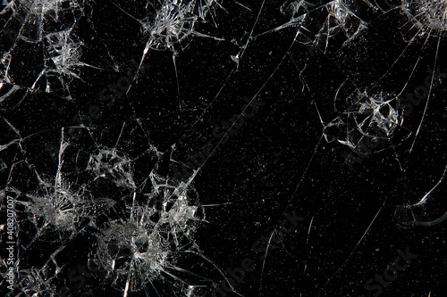 cracks on black glass background, broken abstract glass hole destruction concept