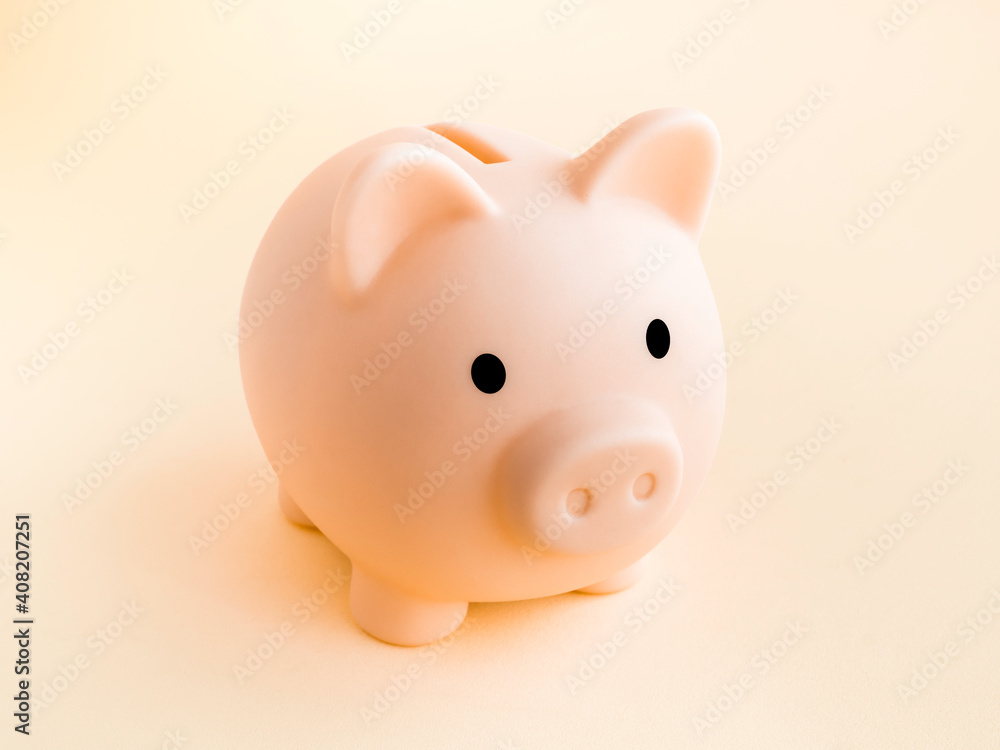 Cute piggy bank, pink color isolated on soft beige background. Saving money, Investment and finance concept.