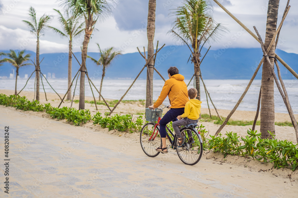 Fototapeta premium Father with his son having a weekend excursion on bike on a summer day in beautiful landscape