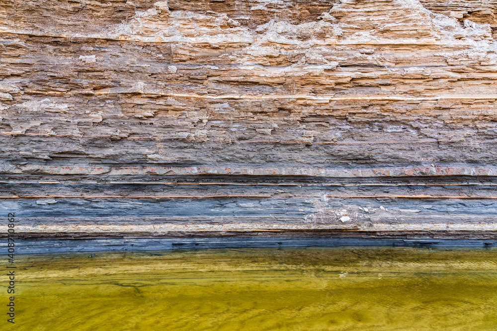 Rock layers above small mountain river - obrazy, fototapety, plakaty 
