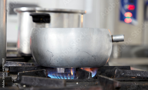 aluminum pot on a gas stove with blue flame