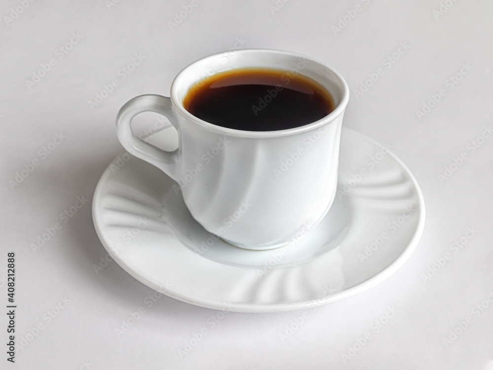 Cup of coffee on a white porcelain saucer Cup of coffee on a white porcelain saucer