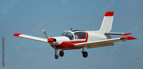 View of light aircraft flying in blue sky photo