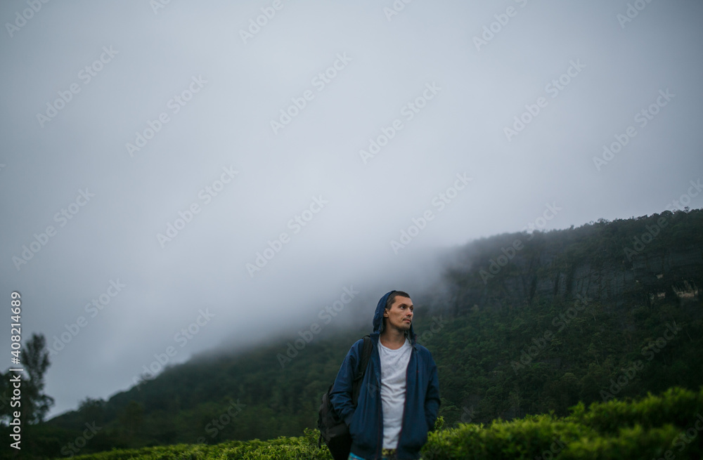 Tourist in the mountains against the background of fog.