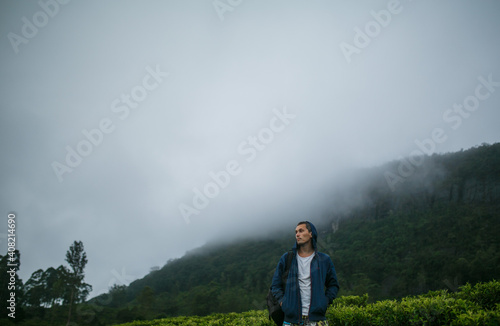 Tourist in the mountains against the background of fog.