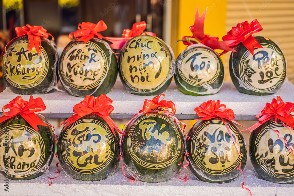 Fototapeta premium Water melons with festive engraving on Tet Eve. Tet is Lunar New Year and celebrated during four days in Vietnam TEXT TRANSLATION from Vietnamese: Congratulations on the Vietnamese, Chinese New Years