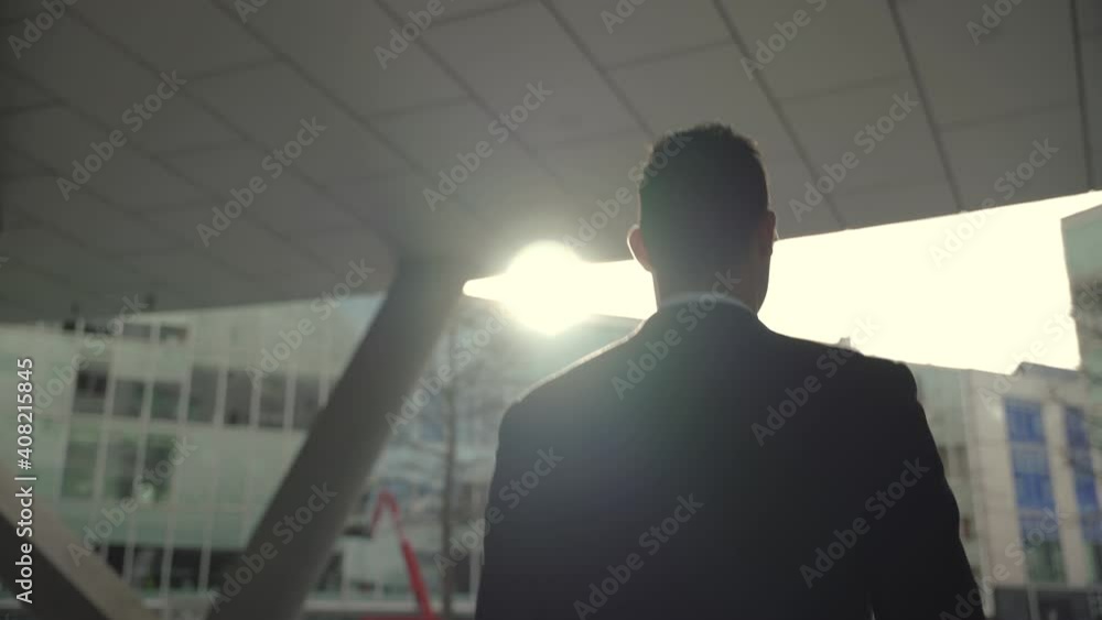 MIxed race businessman walking briskly towards office building MIxed race businessman walking briskly towards office building