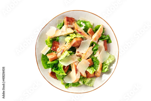 Caesar salad with grilled chicken, green lettuce and Parmesan, isolated on a white background with a clipping path
