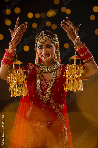 Indian Bride raising her hands showing her Jewellery	 photo