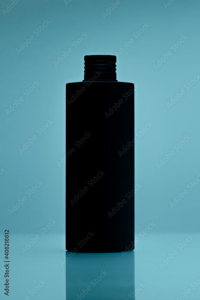 close up of a black bottle on tile blue background. cosmetic mock up. branding identity mockup concept. close up of a black bottle on tile blue background. cosmetic mock up. branding identity mockup concept.