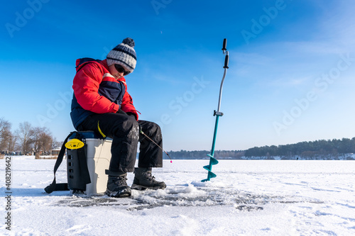Boy enjoys winter fishing