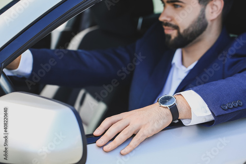 Handsome businessman with stylish wristwatch driving car © Pixel-Shot