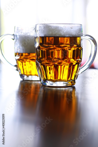Glass of fresh beer on a wooden table. Lager beer mug on stone table. Top view with copy space
