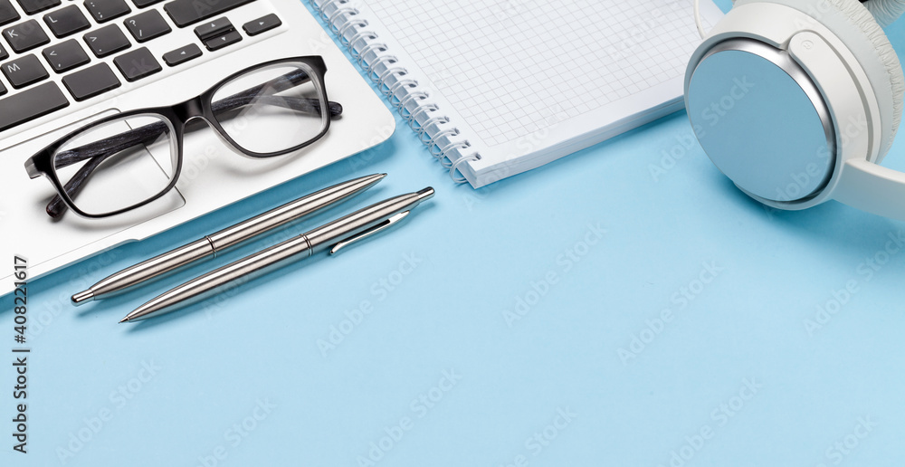 Office desk with supplies, glasses and laptop Office desk with supplies, glasses and laptop