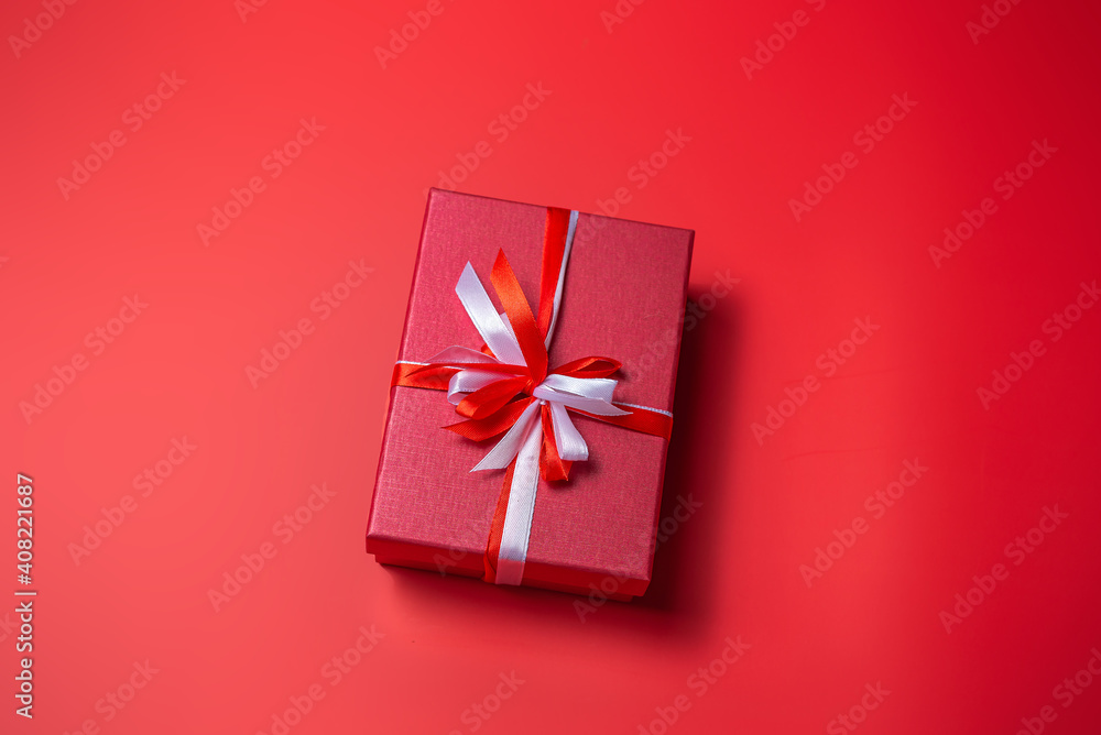 Red gift box with white and red bow on red background top view, Valentines day, Flat lay style with copy space. Red gift box with white and red bow on red background top view, Valentines day, Flat lay style with copy space.