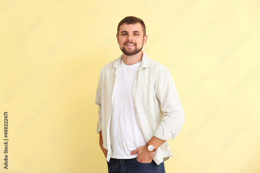 Handsome man with wristwatch on color background Handsome man with wristwatch on color background