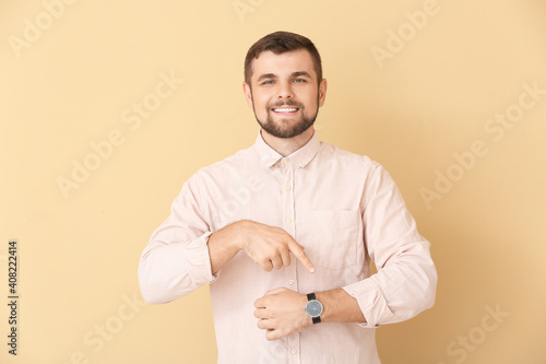 Handsome man pointing at wr...