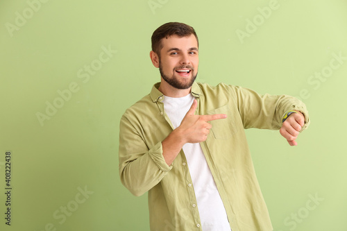Handsome man pointing at wr...