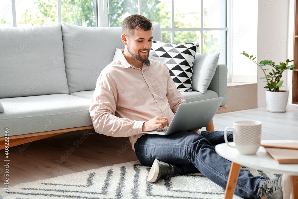 Young man working on laptop at home Young man working on laptop at home