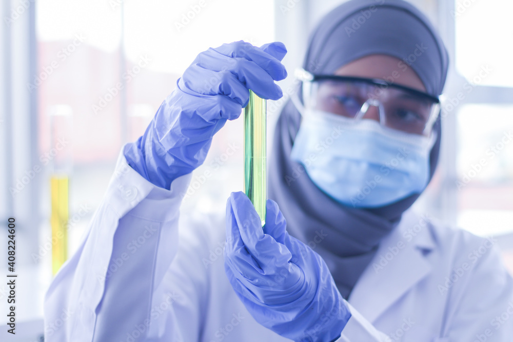 Scientists hold test tubes at the lab Scientists hold test tubes at the lab