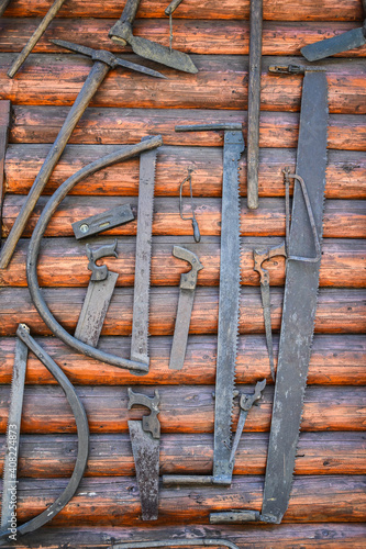 ancient wooden etnographic barn wall with tools. wooden wall photo