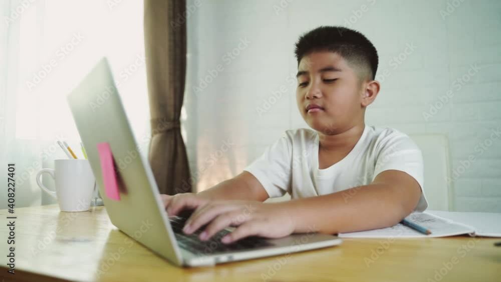 Asian boy student online learning class study online with laptop at home. Asian boy student online learning class study online with laptop at home.
