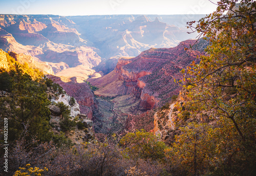 Early morning sunlight brightens the Grand Canyon on the Bright Angel Trail. 