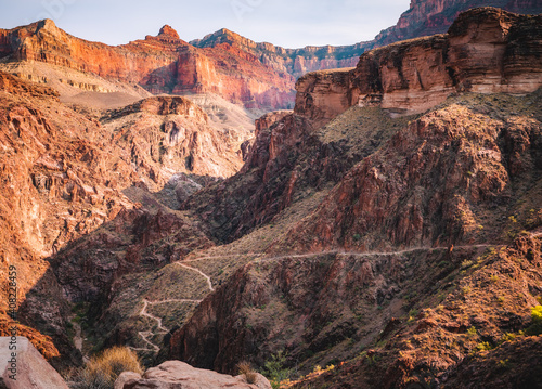 Late afternoon sun casts shadows deep in the Grand Canyon on the Bright Angel Trail.