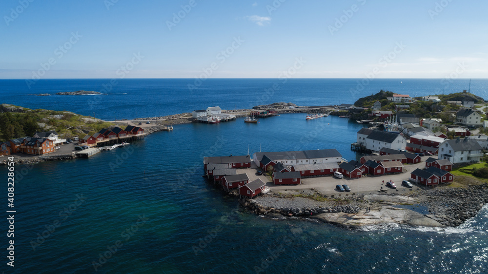 Beautiful summer aerial view of Reine, Norway, Lofoten Islands, with skyline, mountains, famous fishing village with red fishing cabins, Moskenesoya, Nordland