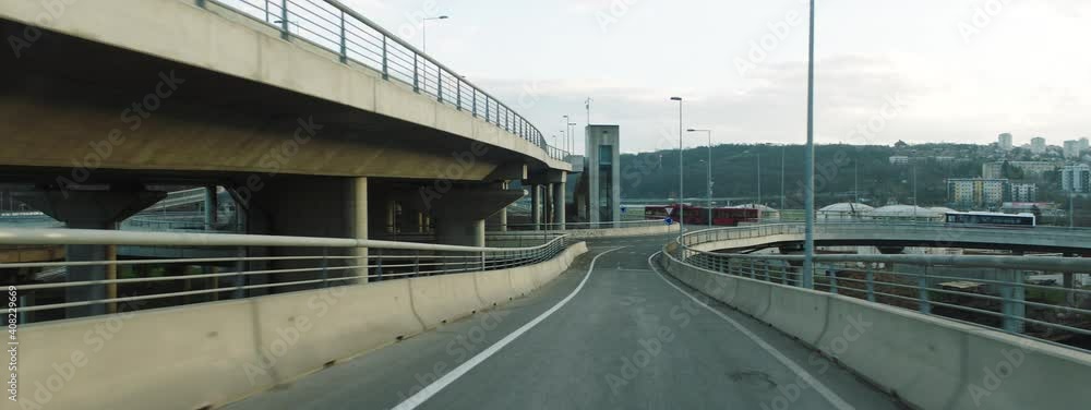 Leaving multiple lane city ring road. Driving on one-way junction arm to roundabout. Car driver's point of view. Leaving multiple lane city ring road. Driving on one-way junction arm to roundabout. Car driver's point of view.