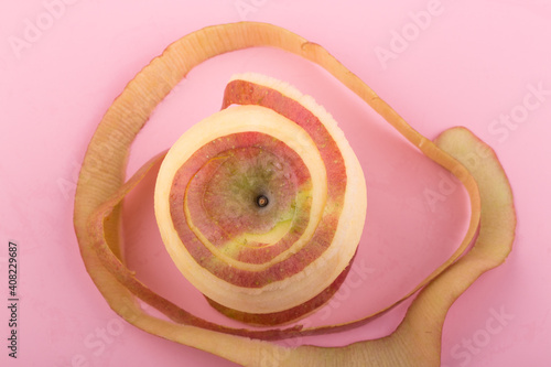Red apple with peeled skin like a spiral.