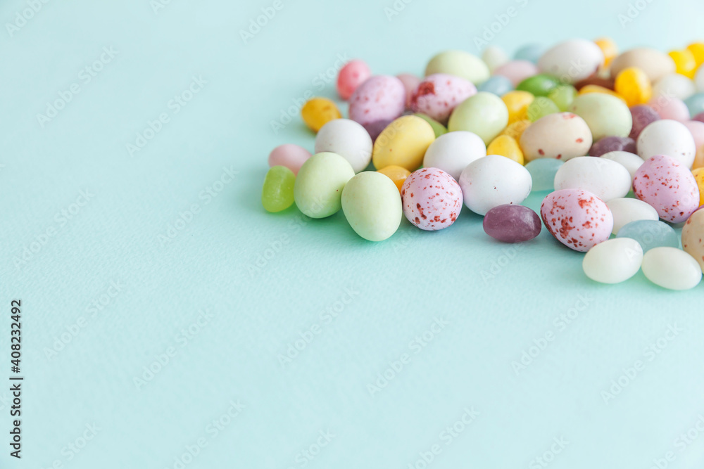 Happy Easter concept. Preparation for holiday. Easter candy chocolate eggs and jellybean sweets isolated on trendy pastel blue background. Simple minimalism flat lay top view copy space. Happy Easter concept. Preparation for holiday. Easter candy chocolate eggs and jellybean sweets isolated on trendy pastel blue background. Simple minimalism flat lay top view copy space.