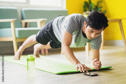 Asian man doing exercise at home
