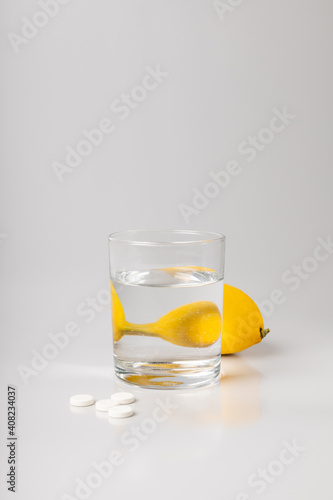 Lemon, a glass of water and medicine