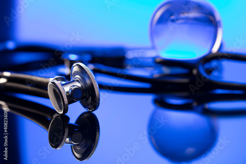 Global healthcare concept. Stethoscope on blue table and background.