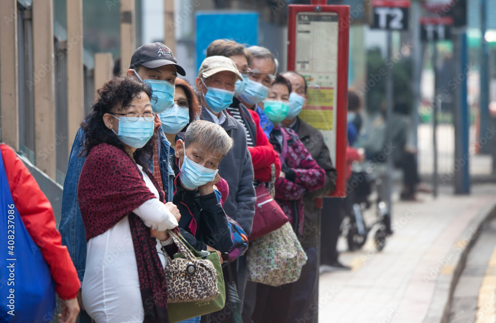 2021 Jan 22,Hong Kong.During the epidemic, citizens wearing masks are waiting for the bus.