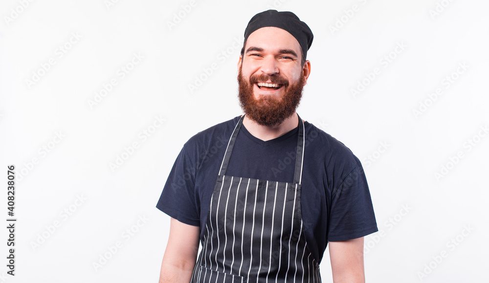 Portrait of smiling bearded chef man over white background.