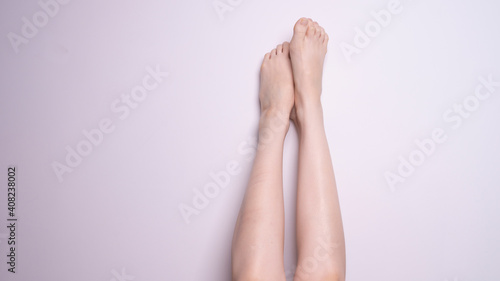 pair of female legs on gray background