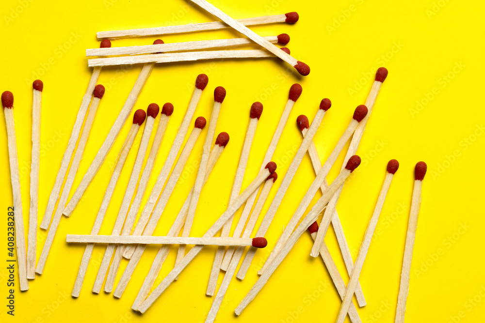 matches are piled on a yellow background close-up. matches are piled on a yellow background close-up.