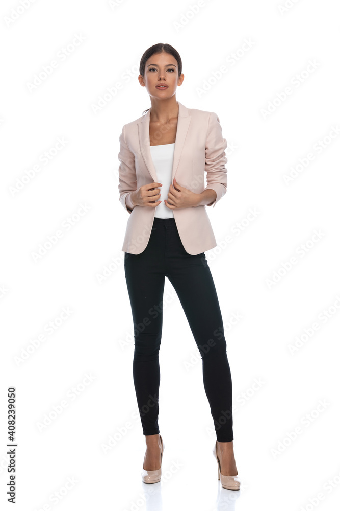 sexy brunette businesswoman adjusting pink jacket and posing sexy brunette businesswoman adjusting pink jacket and posing